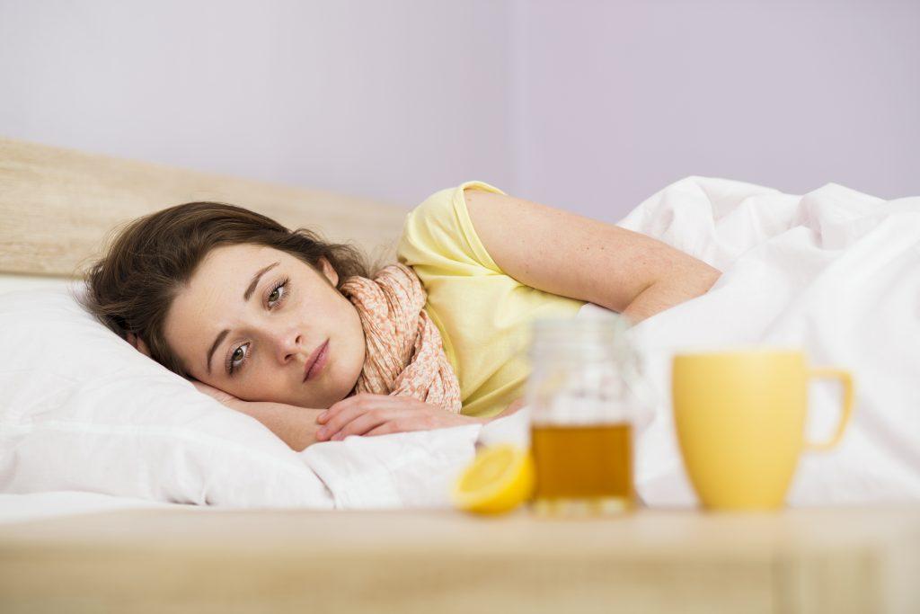 graphicstock-sick-woman-lying-in-bed-with-high-fever-she-has-cold-and-flu-in-front-of-her-is-tea-with-lemon-and-honey_rA_58tnZb-1024x683.jpg